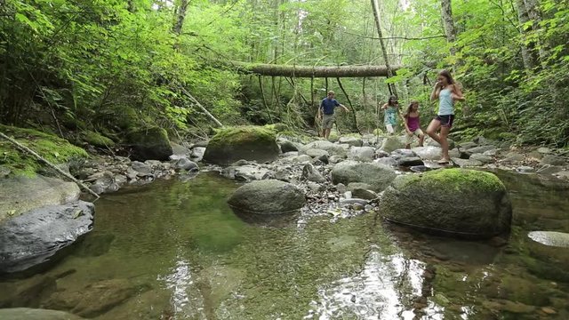 Family walking up creek bed, Bellingham, Washington, United States