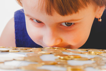 Best motivation is money. Happy business child girl with coints.  (childhood, enrichment, employment concept)