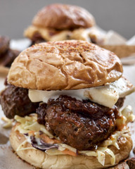 Cheese and meat stuffed burgers with cabbage salad served on the table