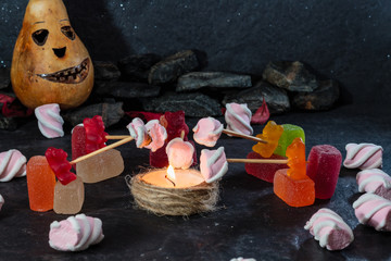 Jelly bears fry marshmallows on fire. Halloween