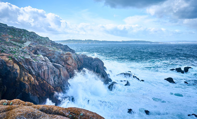 Galician seascape in Coitelada, Ares, La Coruña, Spain. Sea with a lot of waves breaking on the rocks