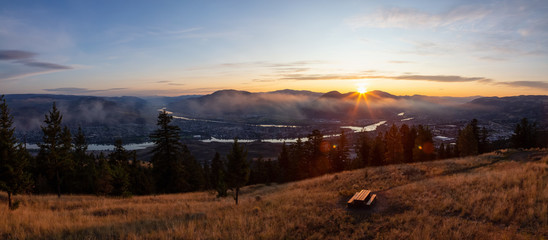Naklejka na ściany i meble Beautiful Panoramic View of a Canadian City, Kamloops, during a colorful summer sunrise. Located in the Interior British Columbia, Canada.