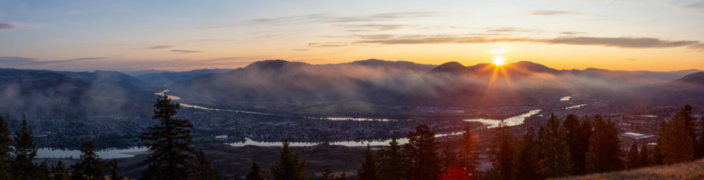 Beautiful Panoramic View of a Canadian City, Kamloops, during a colorful summer sunrise. Located in the Interior British Columbia, Canada.