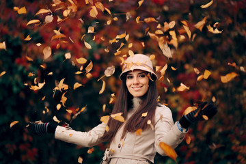 Happy Woman Throwing Autumn Leaves Enjoying Nature
