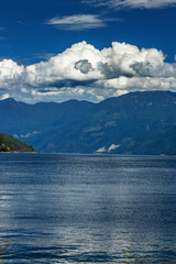 Thick clouds roll over the giant mountains near Earl's Cove, BC