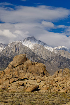 The eroded and rounded rocks with Mt Whitney in the background in the deserts of Alabama Hills California
