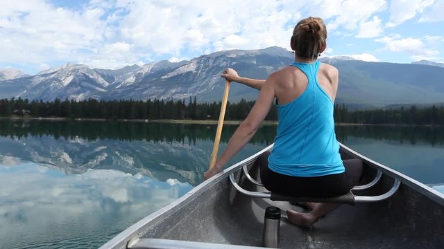 Caucasian woman paddling in canoe, Jasper, Alberta, Canada
