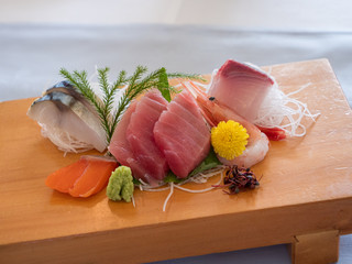Japanese sashimi beautifully presented on a wooden board