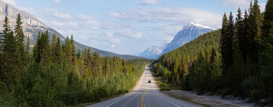 Panoramic View of a Scenic road in the Canadian Rockies during a vibrant sunny and cloudy summer morning. Taken in Icefields Parkway, Banff National Park, Alberta, Canada.