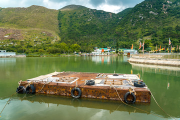 Old rusted water pontoon on the river