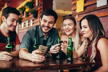 Group of friends having a good time at the bar
