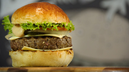 Homemade hamburger with cheese and salad bokeh background