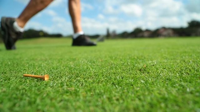 Close up of golfer teeing off