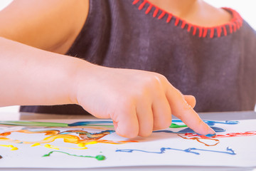 Concept: Learning Is fun! Children's art: happy cute little girl painting paints.