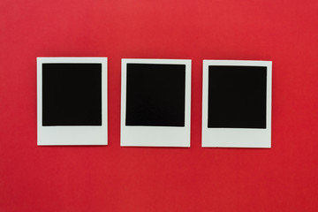 blank polaroids on a red background