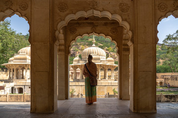 Women traveling in India, Majestic Gaitor Ki Chhatriyan temple, stone carved monuments