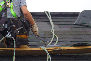 roof repair construction worker roofer man roofing security rope