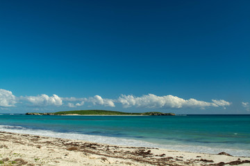 Fototapeta na wymiar Island offshore from mainland with sun shining