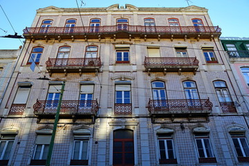Fototapeta na wymiar Traditional colorful buildings with azulejo tiles facade in the old Lisbon neighborhoods Portugal
