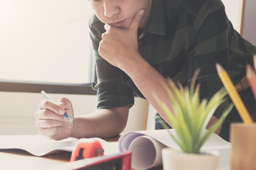Image of engineer drawing a blue print design building or house, An engineer workplace with...