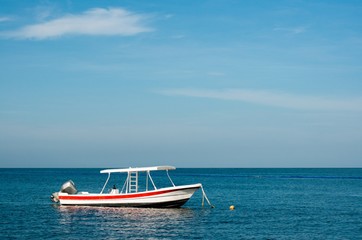 Fototapeta na wymiar Small boat at the Caribbean sea, Mexico, coral reef snorkeling, negative space