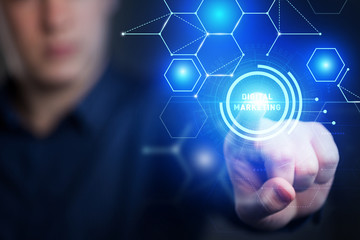 The concept of business, technology, the Internet and the network. A young entrepreneur working on a virtual screen of the future and sees the inscription: Digital marketing