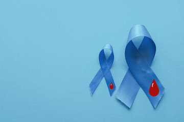 Light blue ribbons with blood on blue background , world diabetes day