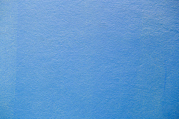 Fine plaster painted wall blue colortexture.