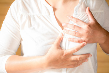 Woman is clutching her chest