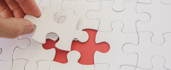 Hands with jigsaw puzzle pieces, Business strategy planning, Alzheimer's disease,  Autism and...