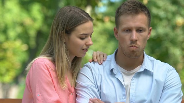 Young woman trying to talk with offended boyfriend, relationship crisis mistrust