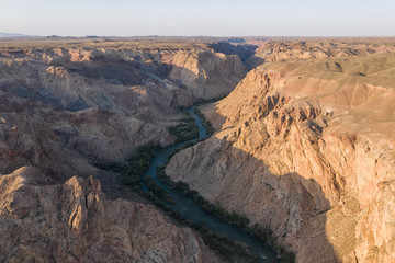 Fototapeta na wymiar Aerial view of the Charyn Canyon and Charyn River in Kazakhstan, Central Asia, at sunset