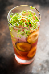 Cocktail with plums and thyme on the rustic background. Selective focus. Shallow depth of field.
