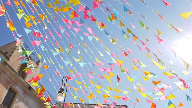 rotating shot on ornamental coloured flag in the town of Oliena for the Cortes Apertas festival