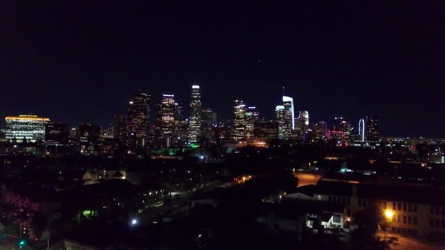 Wide aerial shot of downtown Los Angeles skyline at night. 4K