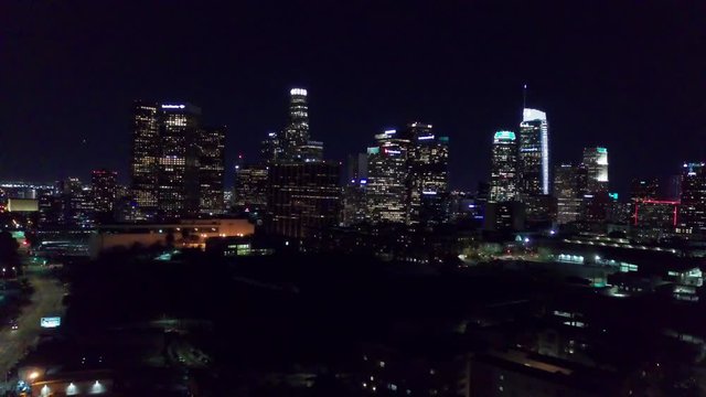 Slow rising panorama of downtown Los Angeles skyline at night. 4K