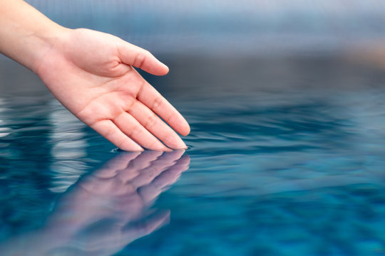 Closeup image of a hand soaking into clear water