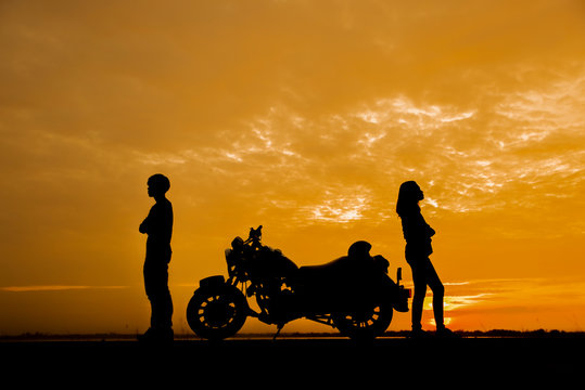 Break Up,Bad Relationship,Anger,unhappy, Concept.Silhouette Of Anger Of Couples Love Who Are Quarreling (argument) And Standing Back To Back With Motorcycle Against Beautiful Sunset Background In Thai