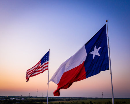 American and Texas Flags against sky | Flags at Sunset with heavy vignette