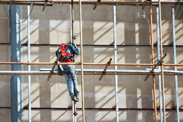 Fototapeta premium Construction workers on tall buildings