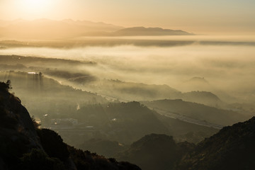 Los Angeles California sunrise view of the fog shrouded 118 freeway and north San Fernando Valley.