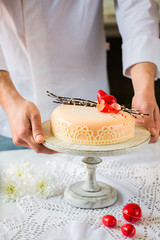 Modern mousse cake for Easter. Festive decor with chocolate eggs.