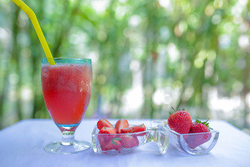 strawberry shake and fresh strawberry or cocktail nature background. juice drink.