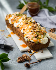 Carrot cake (bread, pie) with nuts, cheese cream and salted caramel. Favorite delicious coffee cake