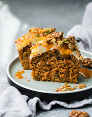 Carrot cake (bread, pie) with nuts, cheese cream and salted caramel. Favorite delicious coffee cake
