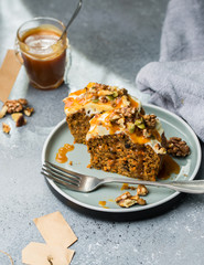 Carrot cake (bread, pie) with nuts, cheese cream and salted caramel. Favorite delicious coffee cake