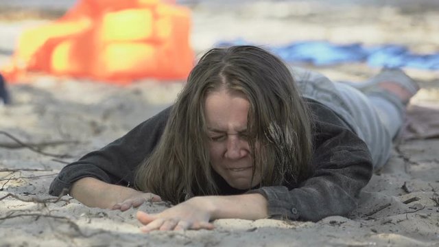 Female spiting out water loosing consciousness after surviving in plane crash