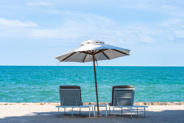 Beautiful umbrella and chair around beach sea ocean with blue sky for travel