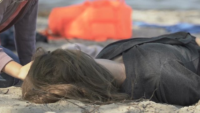 Desperate little girl trying to wake up dead mother after shipwreck catastrophe