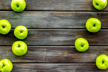 Green apples pattern on dark wooden background top view frame copy space